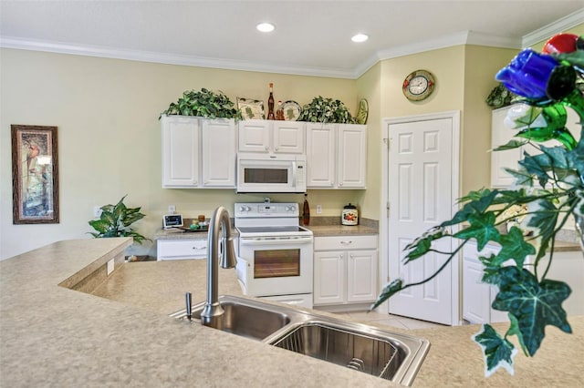 kitchen with ornamental molding, white appliances, light tile patterned floors, and white cabinets