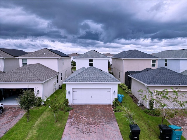 view of front of home featuring a garage and a front lawn