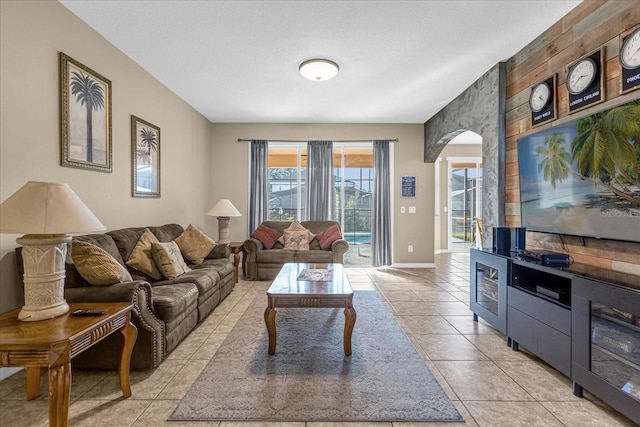 living room featuring light tile patterned floors and a textured ceiling