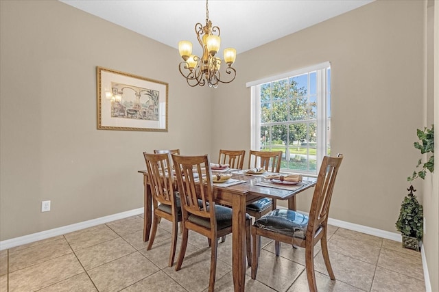 tiled dining area featuring a chandelier