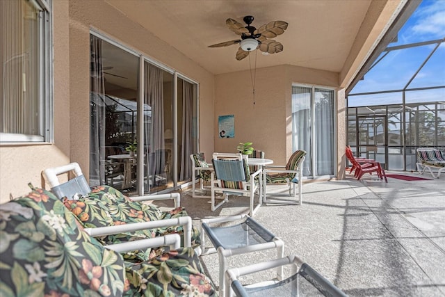 sunroom / solarium featuring ceiling fan