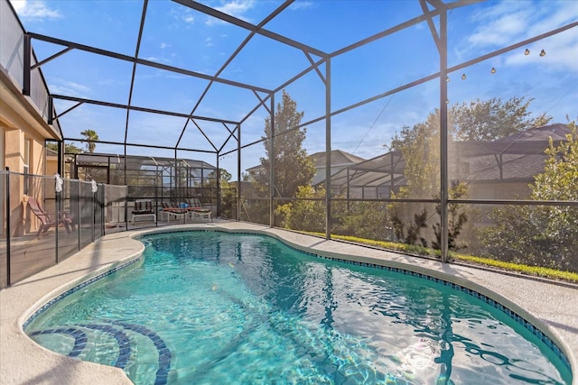 view of swimming pool with a patio and glass enclosure