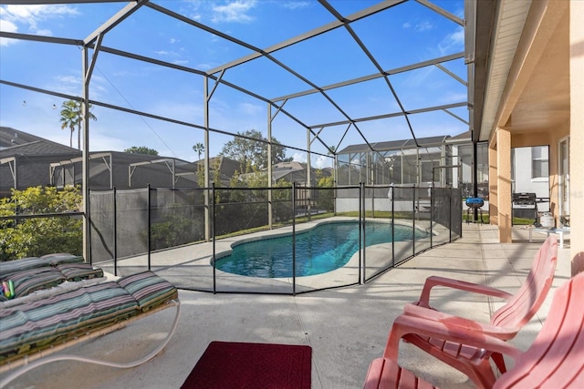 view of swimming pool featuring a lanai and a patio area