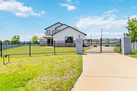 view of gate featuring a yard