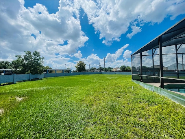 view of yard with glass enclosure