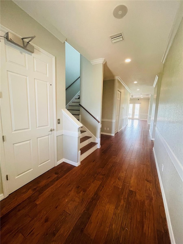 hall featuring dark wood-type flooring and ornamental molding