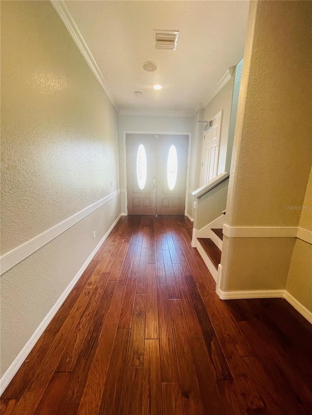 doorway with crown molding and dark wood-type flooring