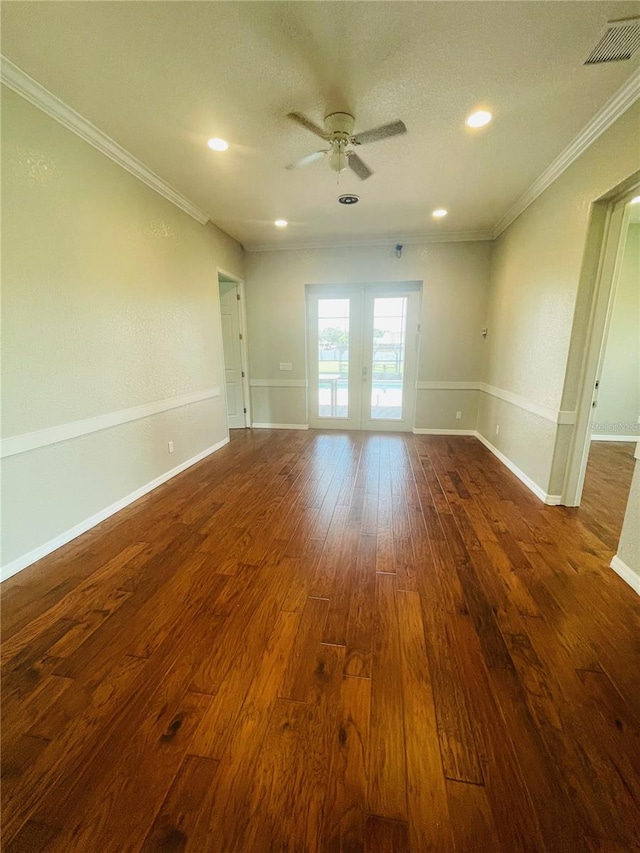 spare room with ceiling fan, dark hardwood / wood-style floors, crown molding, and french doors