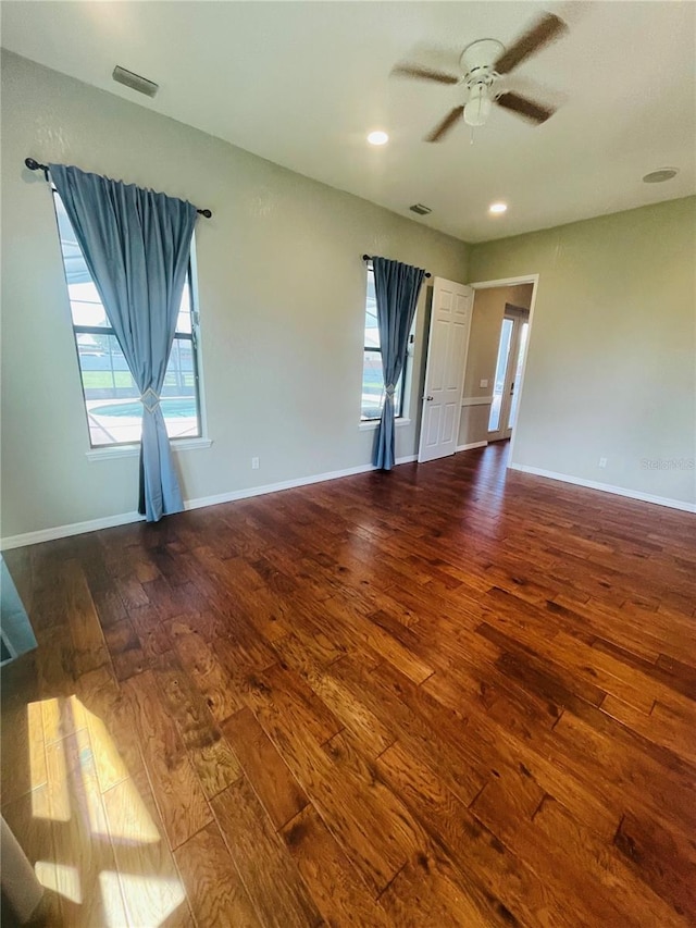 spare room with ceiling fan and dark hardwood / wood-style floors