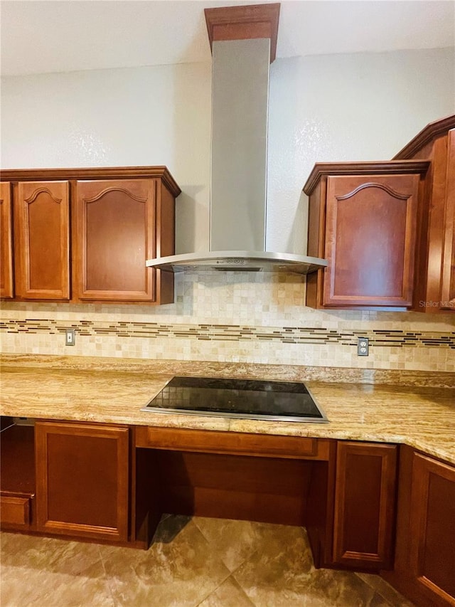 kitchen with backsplash, black electric stovetop, light stone countertops, and wall chimney range hood