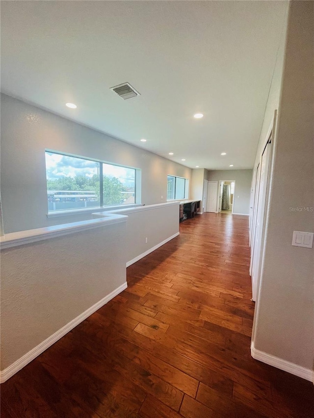 corridor with dark wood-type flooring