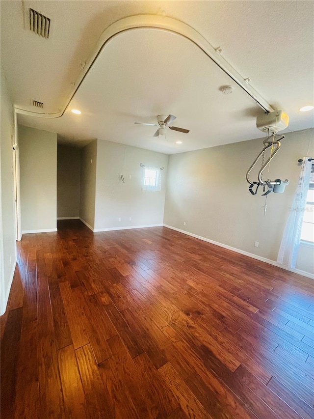 spare room with ceiling fan and dark hardwood / wood-style flooring