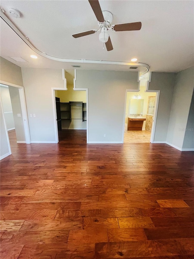 unfurnished living room with ceiling fan and dark hardwood / wood-style floors