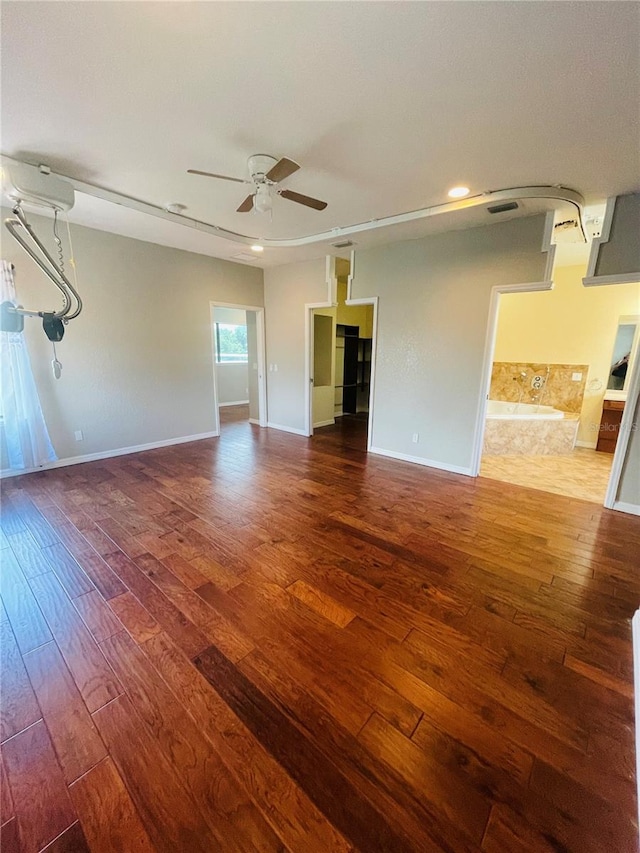 unfurnished living room with ceiling fan and dark hardwood / wood-style flooring