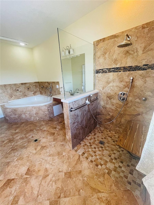 bathroom featuring shower with separate bathtub and vanity