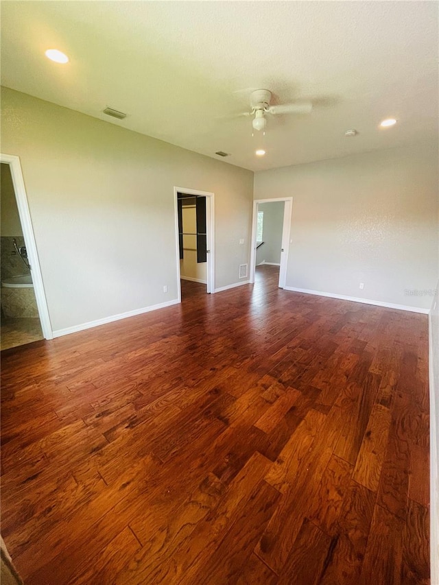 empty room with ceiling fan and dark hardwood / wood-style floors