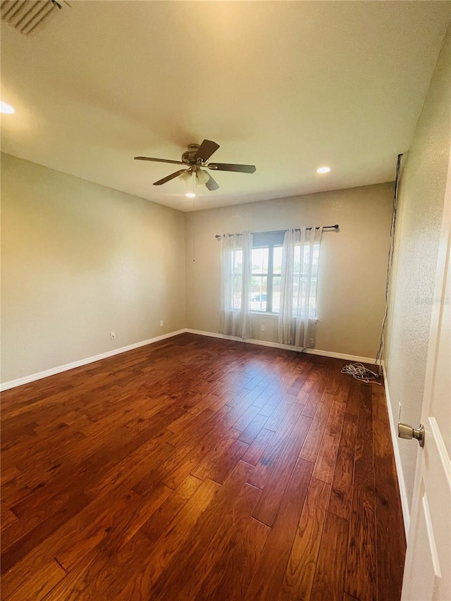 spare room featuring ceiling fan and dark hardwood / wood-style flooring