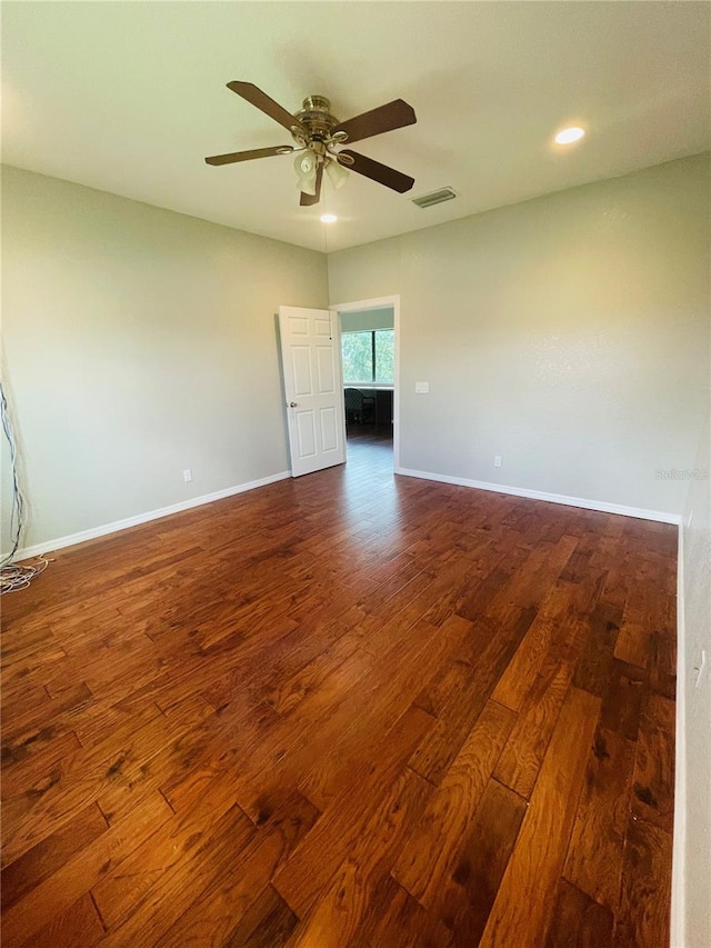 empty room featuring ceiling fan and dark hardwood / wood-style flooring