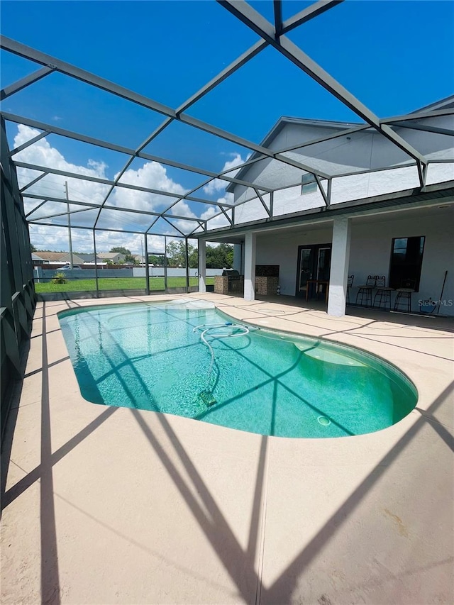 view of pool featuring a patio area and glass enclosure