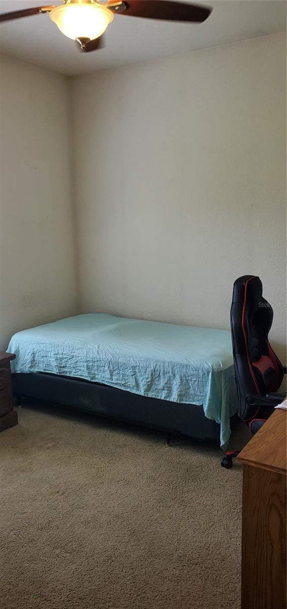 carpeted bedroom featuring ceiling fan