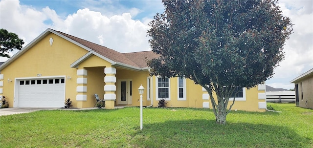 view of front of home with a garage, a front yard, fence, and stucco siding