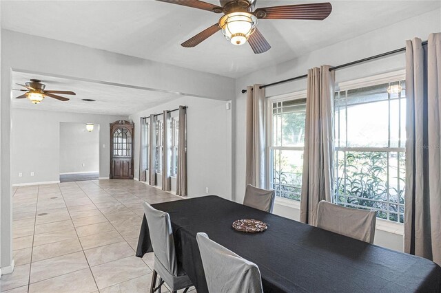 dining space featuring ceiling fan and light tile patterned floors