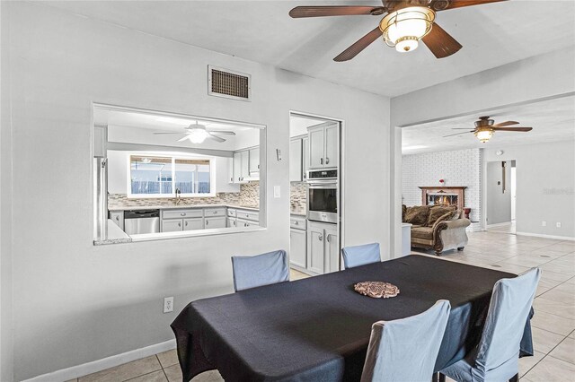 dining area with sink and light tile patterned floors