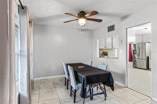 tiled dining room featuring ceiling fan