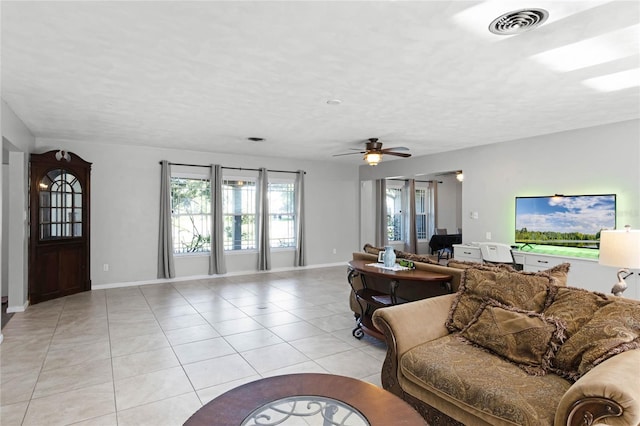 tiled living room featuring a textured ceiling and ceiling fan