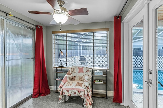 living area featuring ceiling fan, a healthy amount of sunlight, and light tile patterned floors