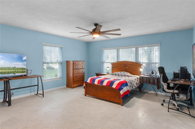 bedroom featuring multiple windows and ceiling fan