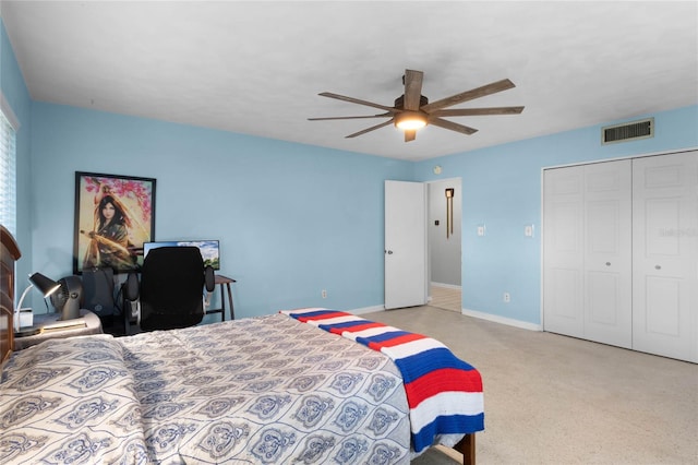 bedroom featuring ceiling fan, light colored carpet, and a closet