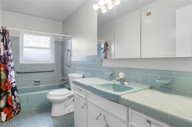 full bathroom featuring shower / tub combo, tile patterned floors, vanity, tile walls, and toilet