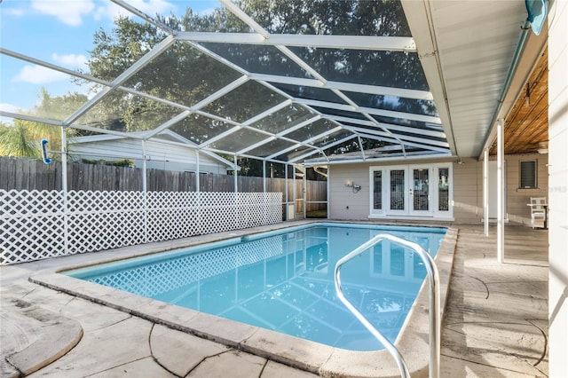 view of pool with a lanai, a patio, and french doors