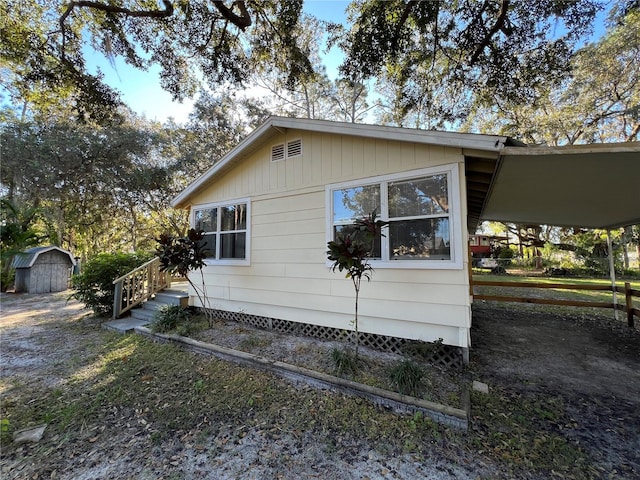 view of side of property featuring a shed and a carport