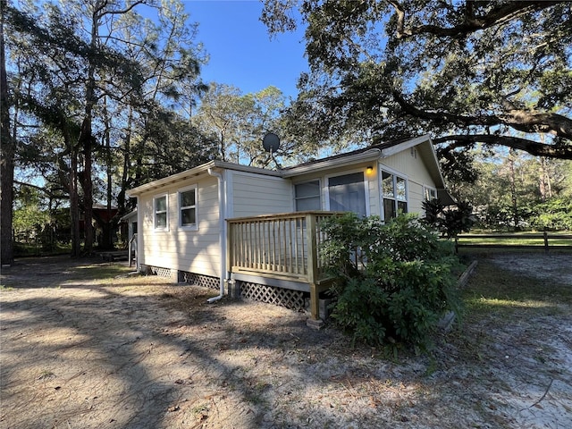 view of property exterior with a wooden deck