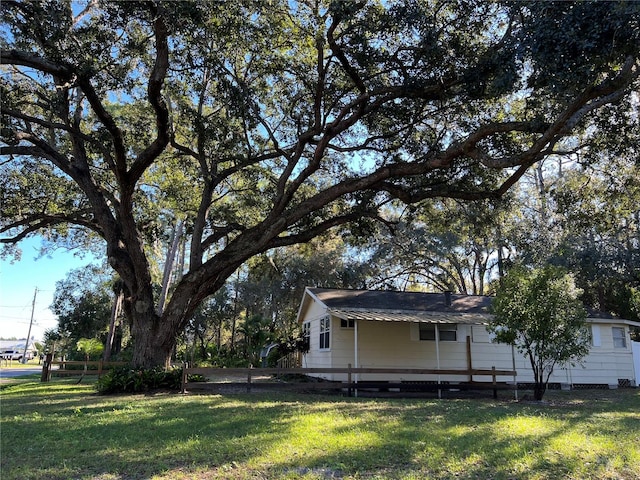 view of side of home with a lawn