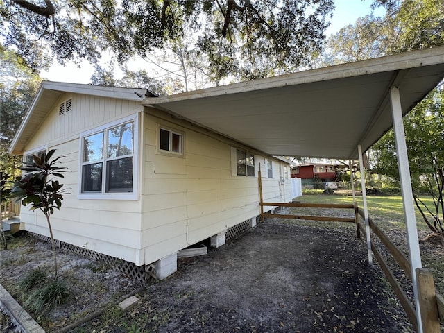 view of side of home with a carport