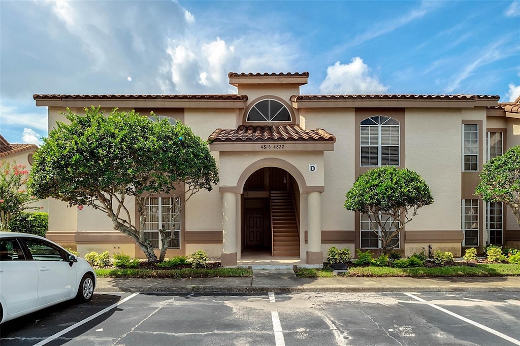 view of building exterior featuring uncovered parking