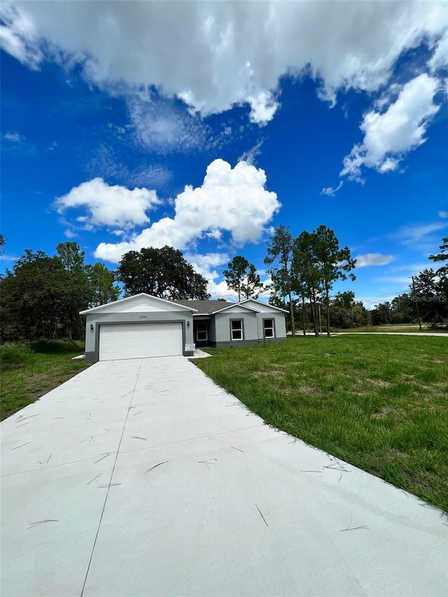 view of front facade with a garage and a front lawn