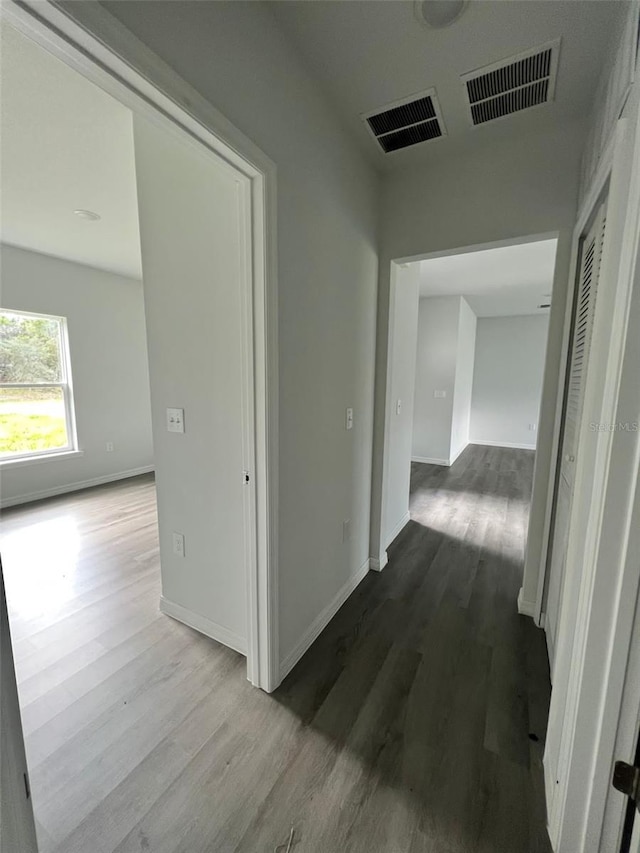 hallway with hardwood / wood-style floors