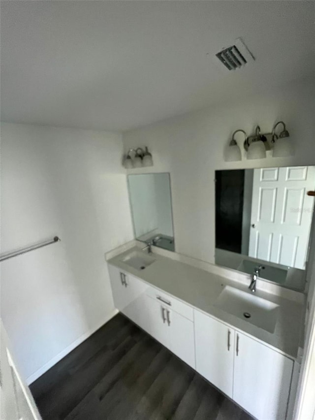 bathroom featuring vanity and hardwood / wood-style floors