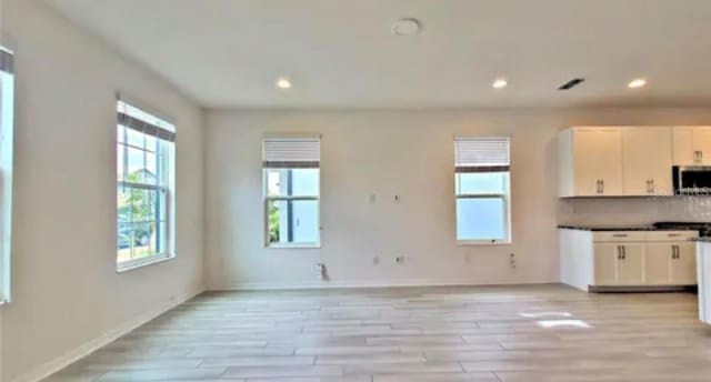 unfurnished living room with light hardwood / wood-style floors