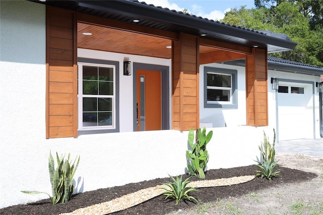 doorway to property with a garage