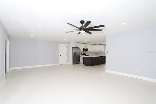 unfurnished living room featuring ceiling fan