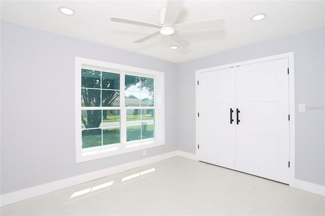 interior space with ceiling fan