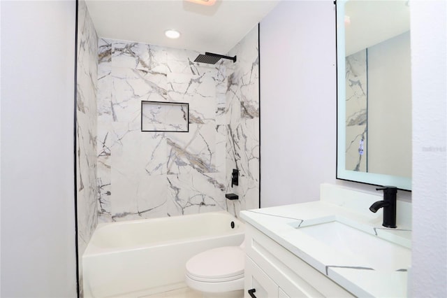 full bathroom with vanity, tiled shower / bath combo, and toilet