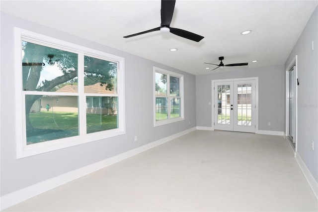 spare room featuring ceiling fan and french doors