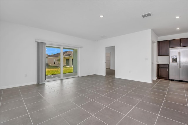 unfurnished living room with light tile patterned floors