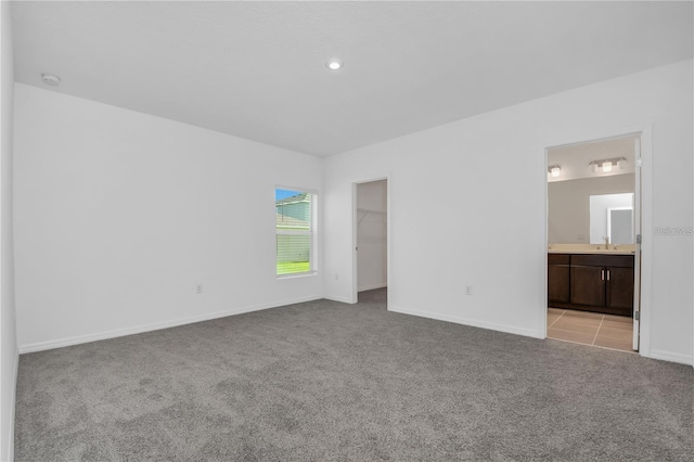 unfurnished room featuring light carpet